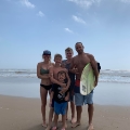 family posing at beach