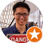 young smiling man with glasses holding Danger sign